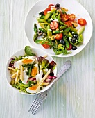 Green asparagus salad on plate and eggs and cheese salad in bowl