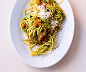 Spaghetti with tomato and pesto on plate