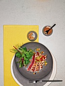 Tuna with guacamole and mesclun salad on plate