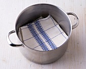 Folded kitchen towel in pot