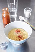 Instant couscous and paprika in a bowl