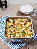 Cheese Spätzle (soft egg noodles from Swabia) with mushrooms in a baking dish