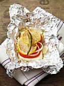 Feta parcel with tomatoes in tin foil