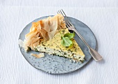 Piece of ricotta herb cake with fork on plate