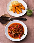 Pumpkin with couscous and salsa with seitan goulash on plates