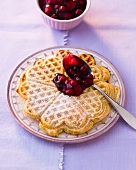 Waffles with berry compote and wine on plate