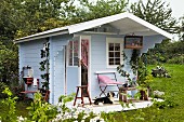 Blue, wooden, Scandinavian-style summer house used as artist's studio