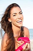 Laughing brunette woman with tanned skin