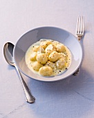 Gnocchi with gorgonzola sauce in bowl