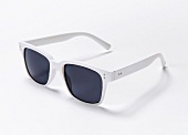 Close-up of sunglasses with white frame on white background