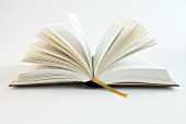 Close-up of open book with yellow bookmark on white background