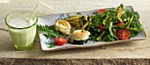 Herb salad with goat's cheese tart in serving dish
