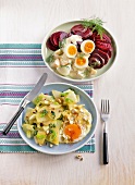 Eggs ragout with beetroot and turnip greens with egg on plates