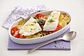 Baked fish with vegetables in serving dish