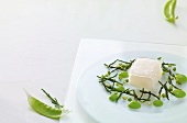 Cod fish with aloe vera jelly, lemon grass and peas on plate