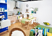 Kitchen cabinets with dining table and green sofa on wooden floor