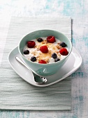 Curd with walnut, berries and spelt flakes in bowl