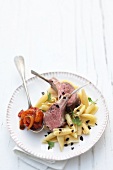 Garganelli with rack of lamb and tomato chutney on plate