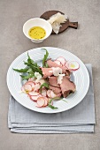 Roasted beef with radish salad on plate