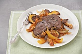 Roasted beef with vegetables on plate