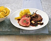 Veal medallions with oyster mushrooms and noodles on plate