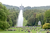 People in Bergpark Wilhelmshohe in front of octagon fountain in Kassel, Hessen, Germany