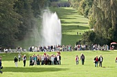 People in Bergpark Wilhelmshohe in front of octagon fountain in Kassel, Hessen, Germany