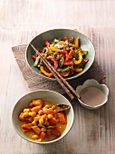 Asian stir-fried vegetables with chopstick and pumpkin curry in bowl