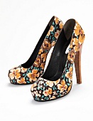 Floral patterned pumps on white background