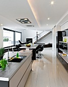 View of open kitchen with narrow kitchen island in black and white