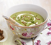 Broccoli cream with crunchy nuts in floral pattern bowl