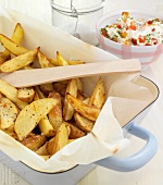 Potato wedges with cheese in serving dish