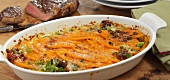 Pumpkin gratin with tomatoes in serving dish