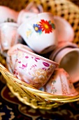 Close-up of decorated porcelain cups in cane basket from Wahiba Sands, Oman