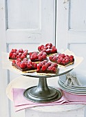Slices of chocolate-raspberry cake on a cake stand
