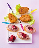 Canapes with pork cutlet and leberpatete on plate
