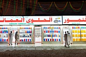 Four men in front of sweet shop in Salalah, Dofar, Oman