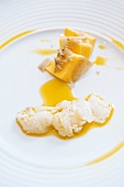 Close-up of raw plaice with polenta, summer truffles and olive oil