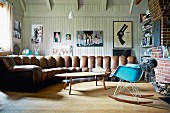 Country-house living room with wood-panelled walls & large, curving sofa