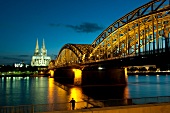 View of Rhine, Hohenzollern bridge and Cologne Cathedral at night in Cologne, Germany