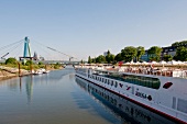 View of A-Rosa Viva river cruise ship in Rhine and Severin Bridge, Cologne, Germany