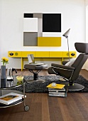 Armchair, table, laptop, with yellow side shelf in living room