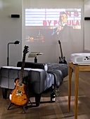 Sofa, guitar, projector screen in wall on living room