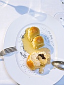 Buns with poppy dumpling and cold vanilla sauce on plate