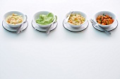 Four different purees and vegetables in bowls