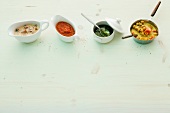 Four different pasta sauces in bowls