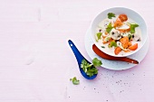 Coconut soup with sweet potatoes in bowl on pink background