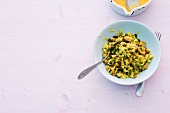 Pea pulao with orange butter in bowl