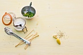 Different ingredients for grill, tongs and chopsticks on wooden background