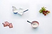 Four different fruits and sweets on white background